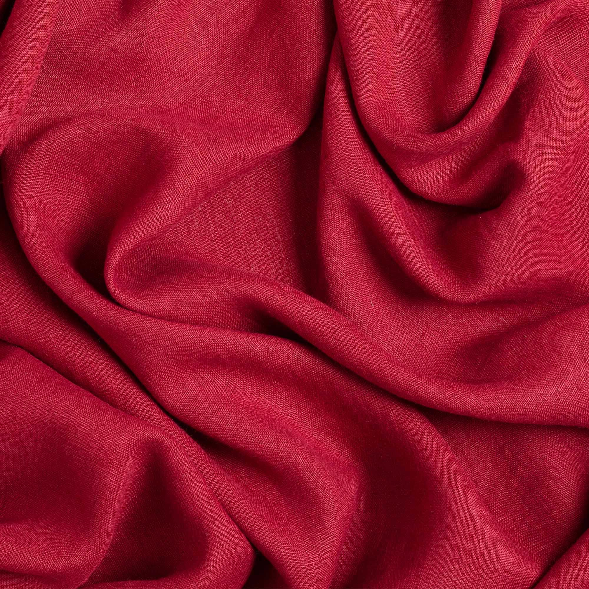 Burgundy linen fabric, crumpled to show its natural texture, washed European flax