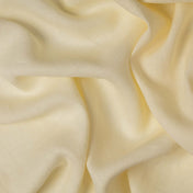 Buttercream linen fabric, crumpled to show its natural texture, washed European flax