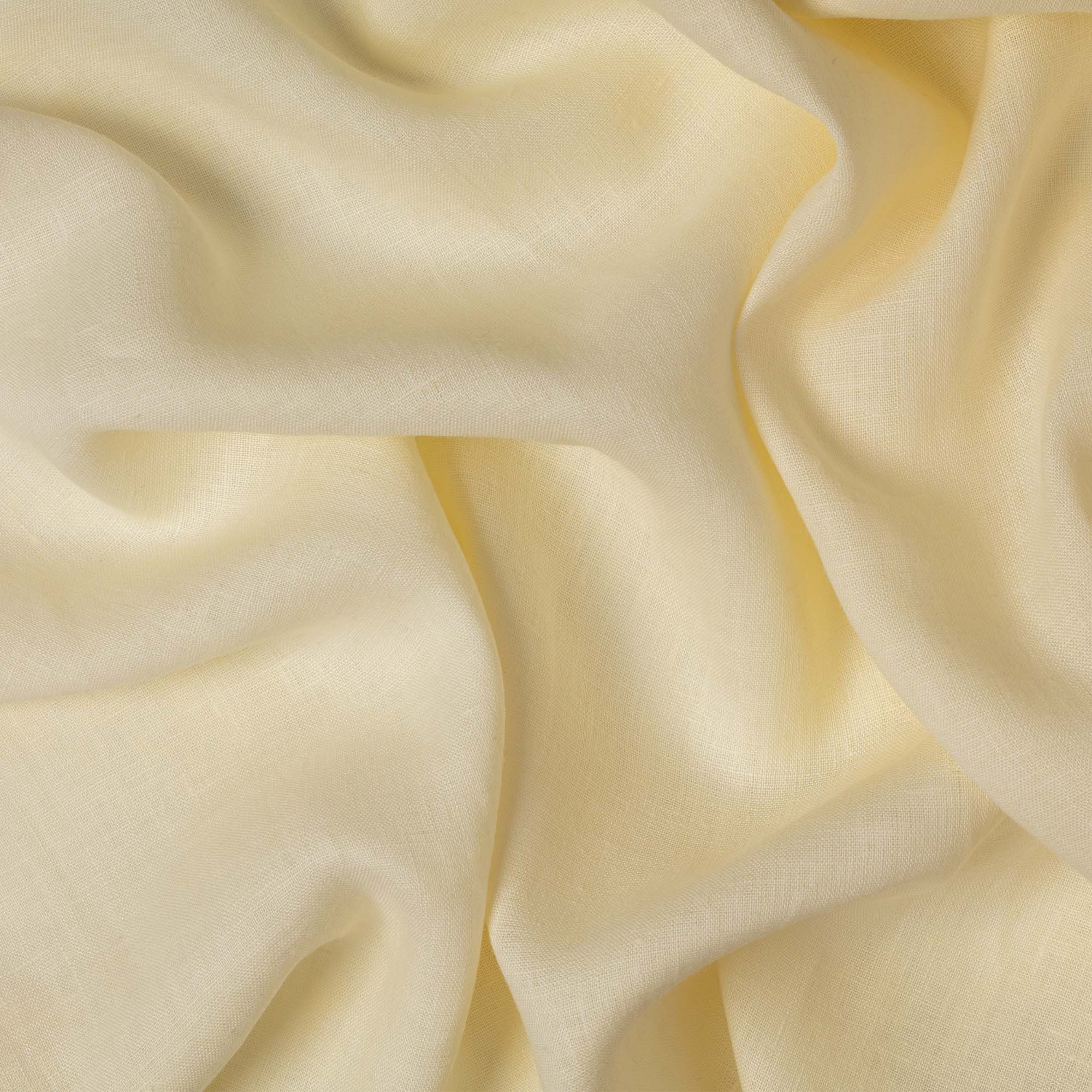Buttercream linen fabric, crumpled to show its natural texture, washed European flax