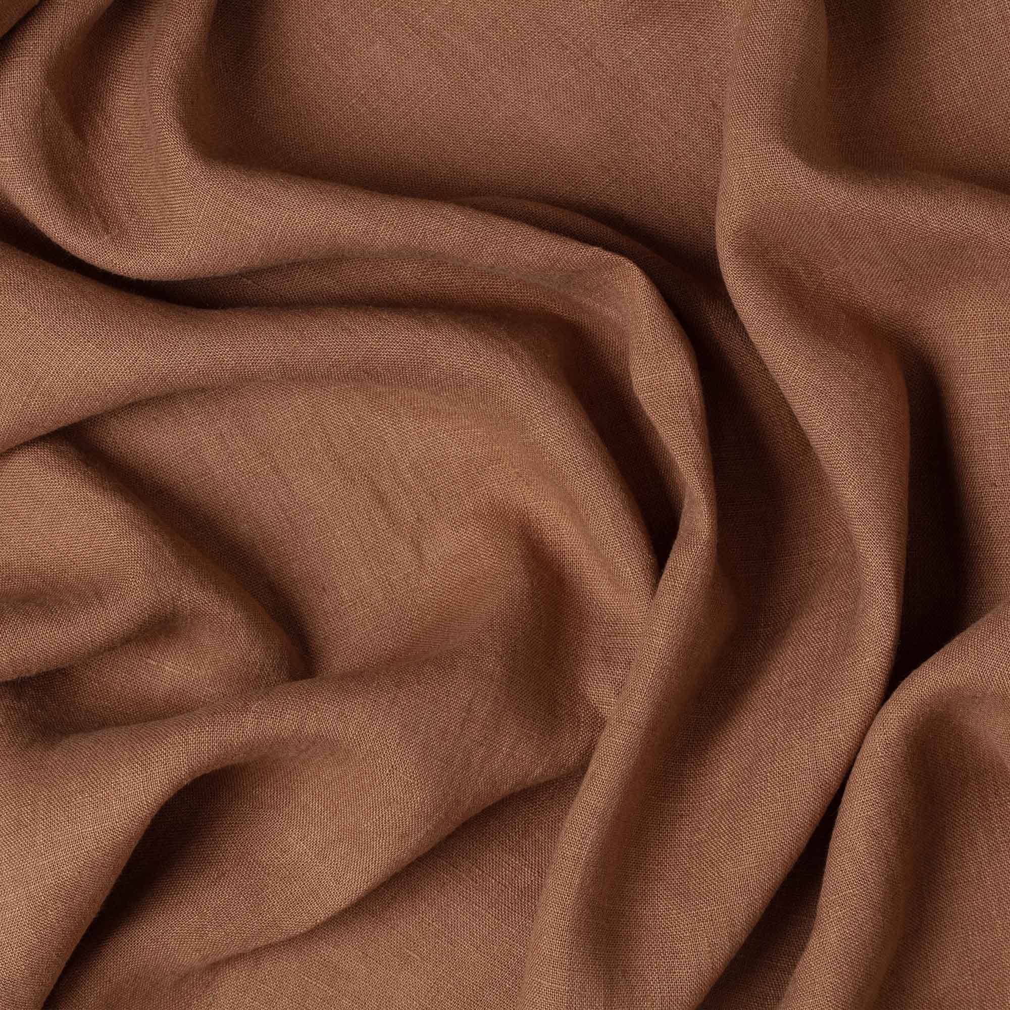 Cinnamon linen fabric, crumpled to show its natural texture, washed European flax