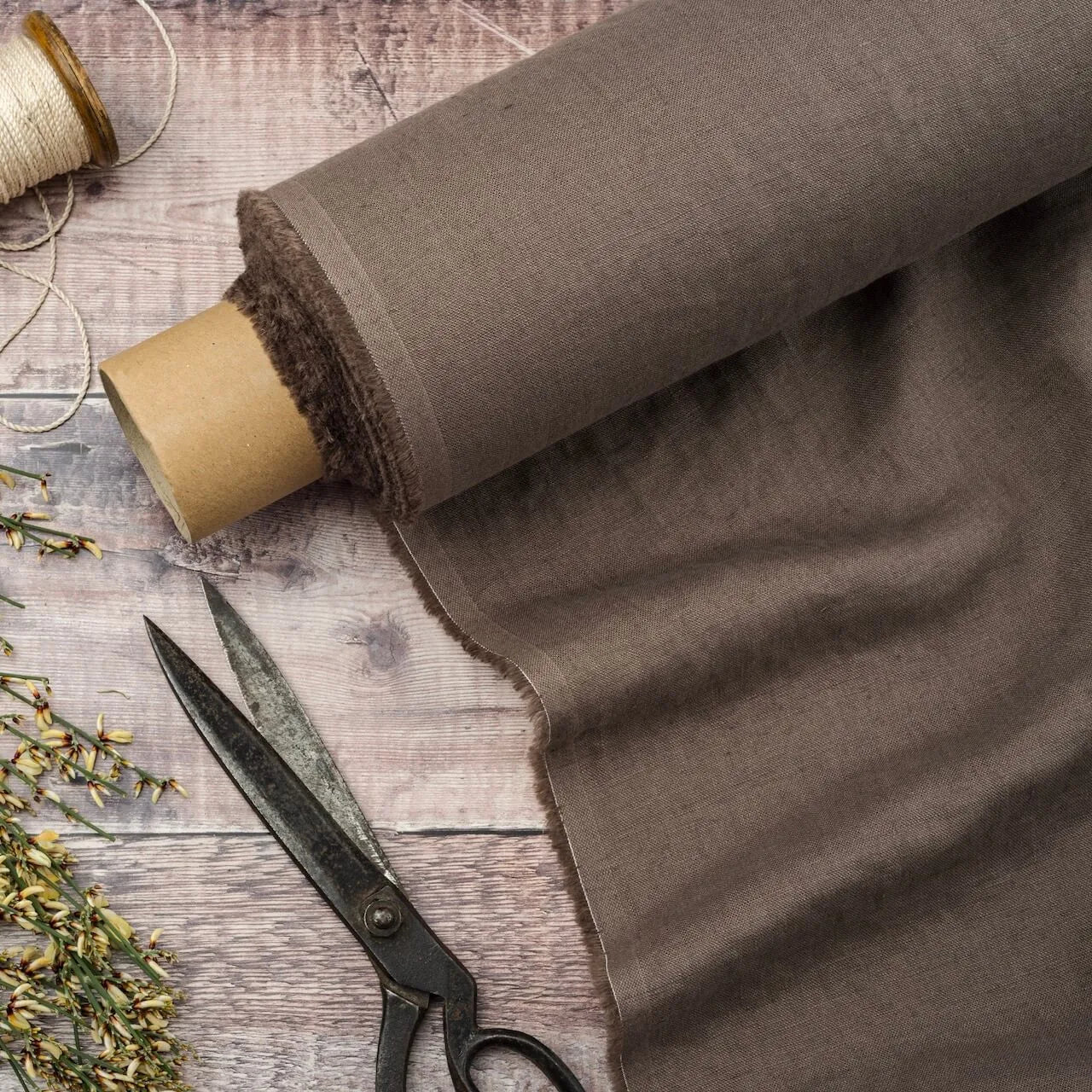 Cocoa Brown linen fabric, ready to cut, with scissors, thread bobbins and flowers