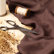Dark Brown linen fabric, ready to cut, with scissors, thread bobbins and flowers