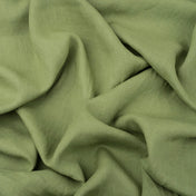 Fern Green linen fabric, crumpled to show its natural texture, washed European flax