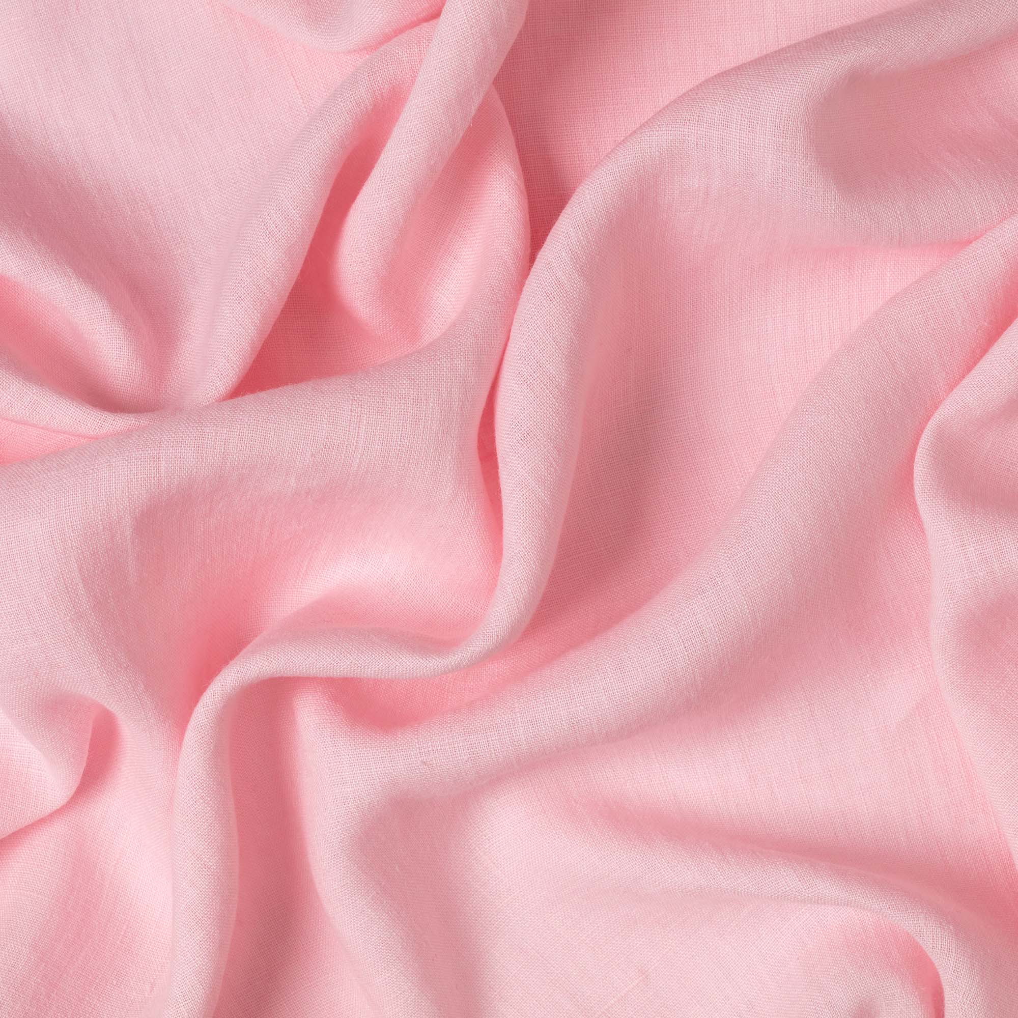 Light Pink linen fabric, crumpled to show its natural texture, washed European flax