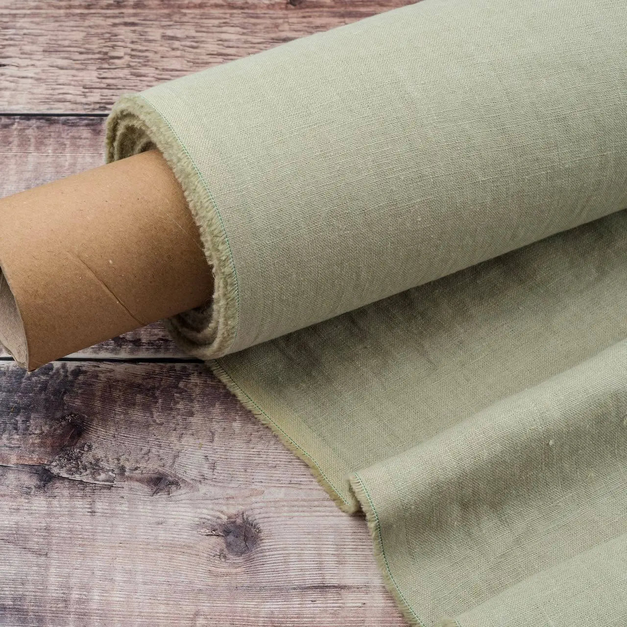 Light Sage Green linen fabric, ready to cut, with scissors, thread bobbins and flowers