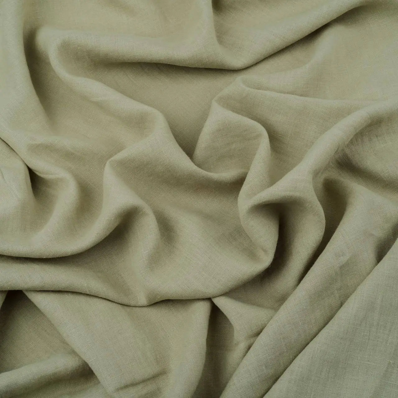 Light Sage Green linen fabric, crumpled to show its natural texture, washed European flax