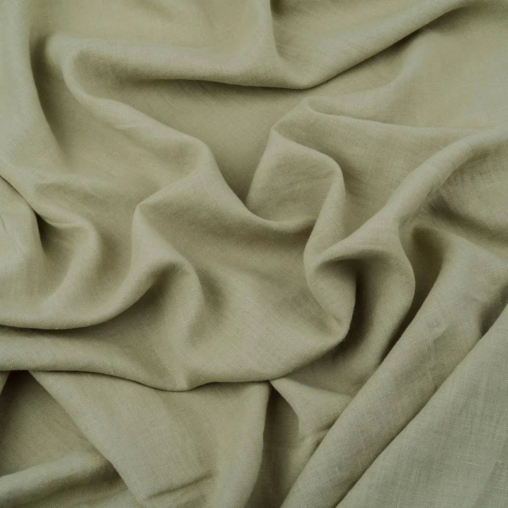 Light Sage Green linen fabric, crumpled to show its natural texture, washed European flax