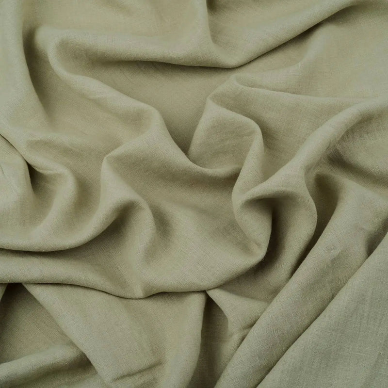 Light Sage Green linen fabric, crumpled to show its natural texture, washed European flax