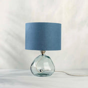 Blue lampshade in textured linen on recycled glass table lamp