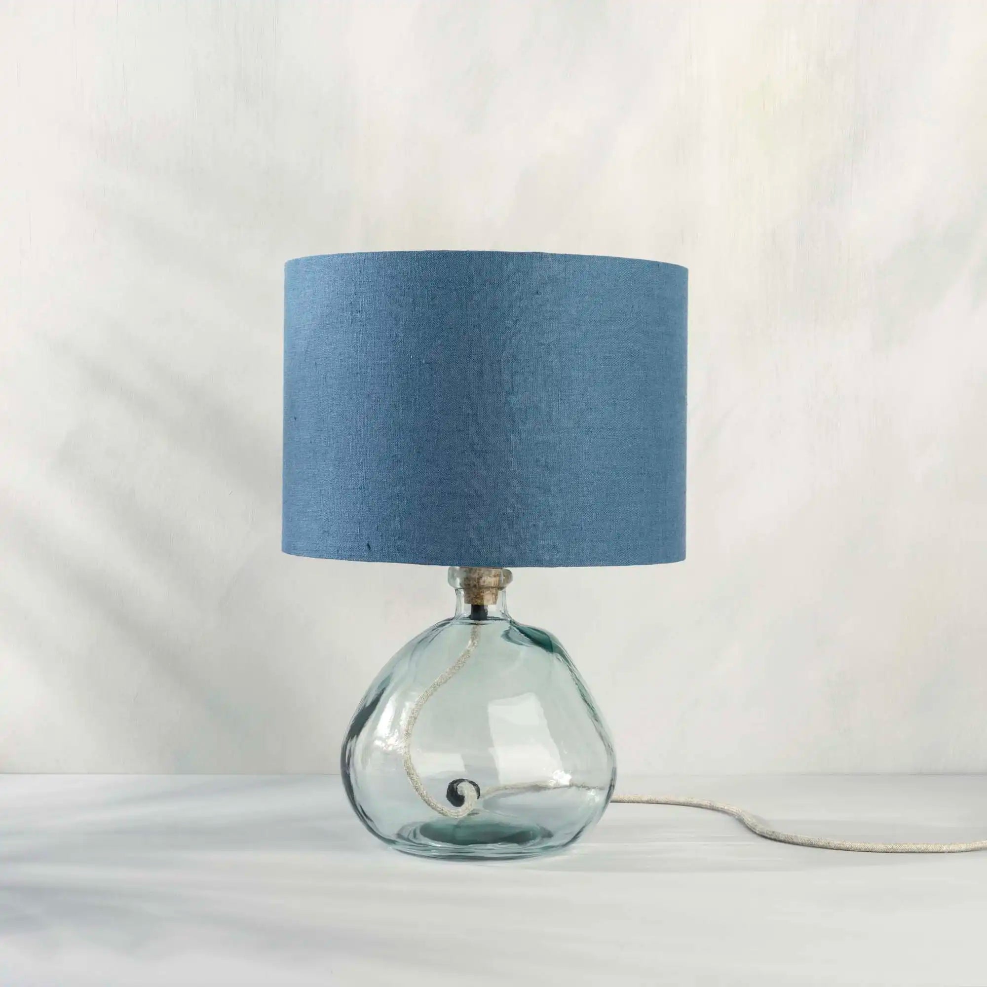 Blue lampshade in textured linen on recycled glass table lamp