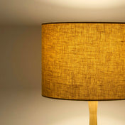 Mustard yellow lampshade in textured linen illuminated 