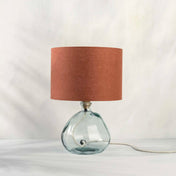 Terracotta lampshade in textured linen on recycled glass table lamp