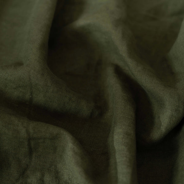 Avocado Green linen fabric, crumpled to show its natural texture, washed European flax