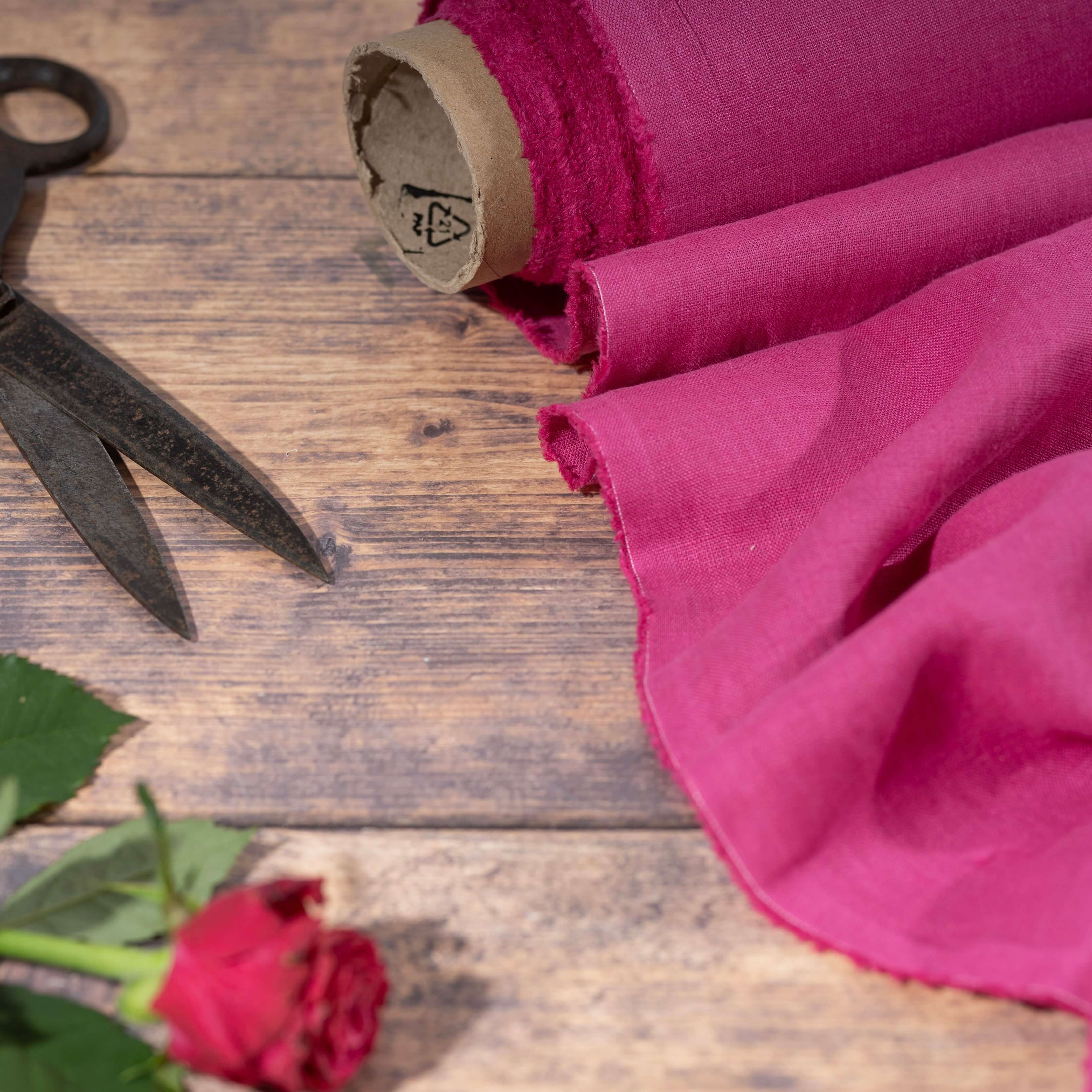 Fuchsia Pink linen fabric, ready to cut, with scissors, thread bobbins and flowers