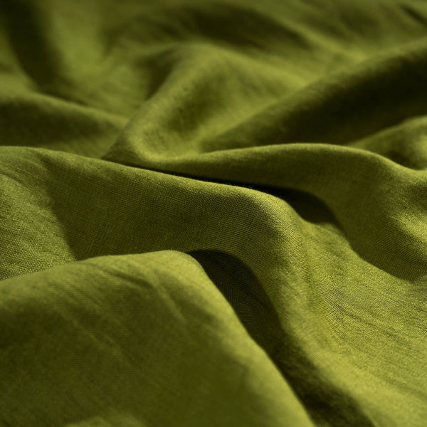 Moss Green linen fabric, crumpled to show its natural texture, washed European flax